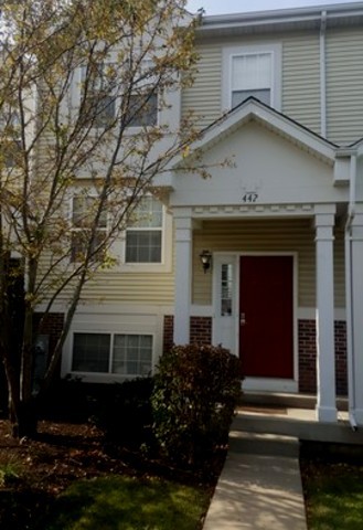 442 Holiday Lane, Unit 402 Round Lake, IL 60073 - Photo 2 of 17 a front view of a house