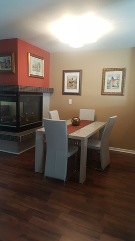 442 Holiday Lane, Unit 402 Round Lake, IL 60073 - Photo 5 of 17 a dining room with furniture and wooden floor