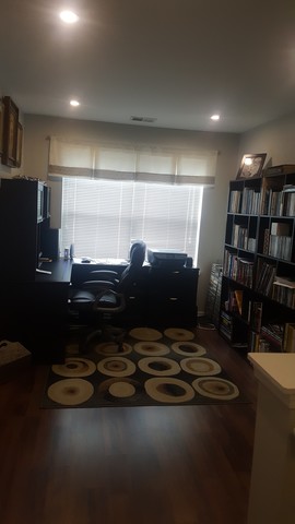 442 Holiday Lane, Unit 402 Round Lake, IL 60073 - Photo 7 of 17 a room with water heater and wooden floor