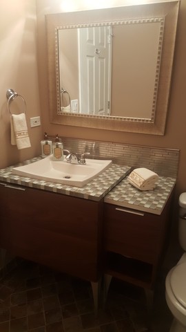 442 Holiday Lane, Unit 402 Round Lake, IL 60073 - Photo 10 of 17 a bathroom with a granite countertop sink and a mirror
