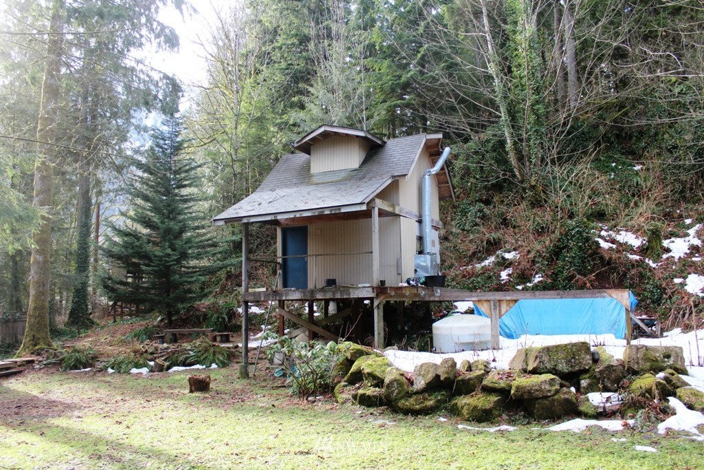 51419 North Riverside Road Gold Bar, WA 98251 - Photo 10 of 24 a backyard of a house with fire pit and outdoor seating
