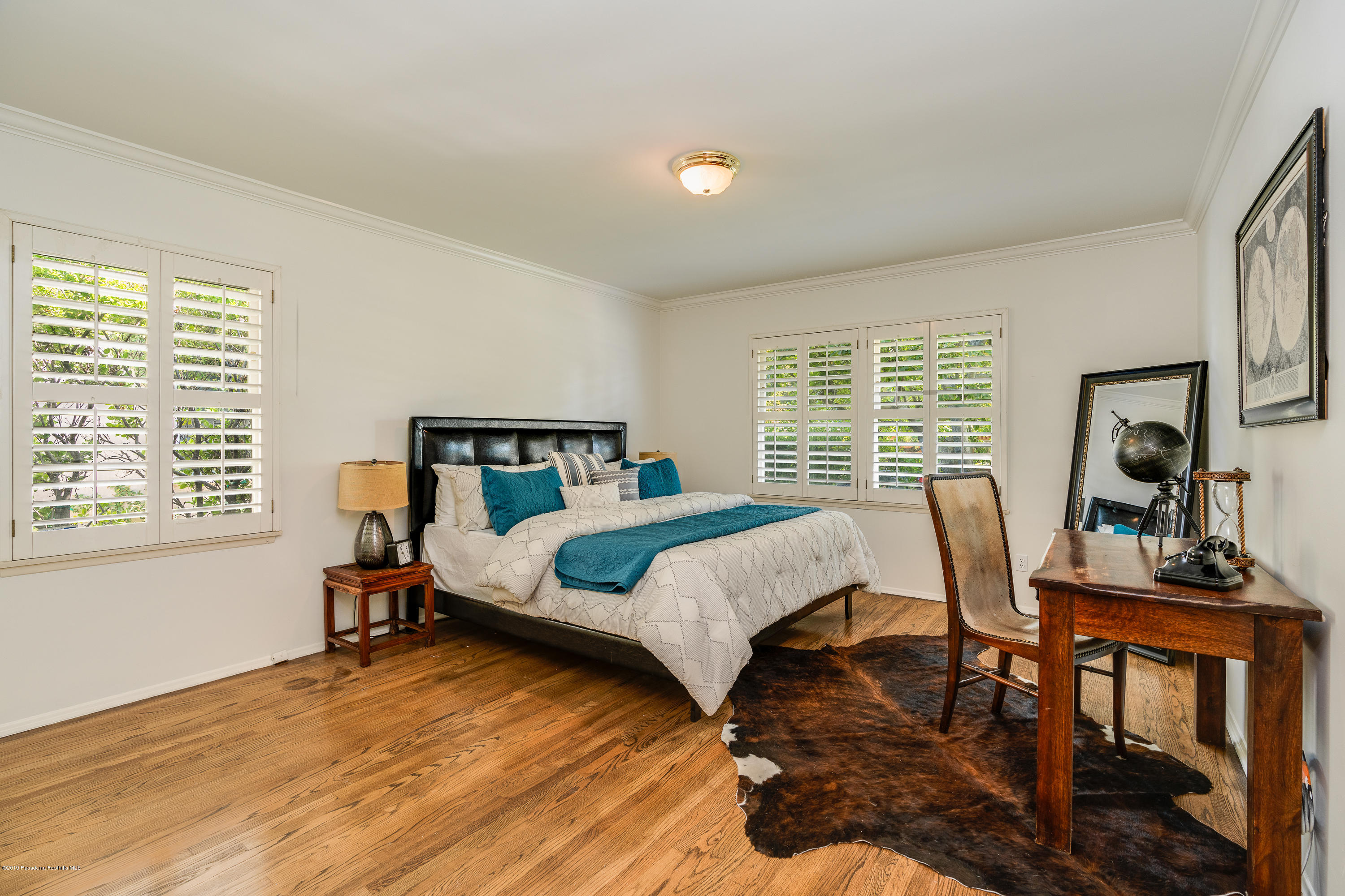 2925 Lorain Road San Marino, CA 91108 - Photo 12 of 18 a bedroom with a bed a table and windows