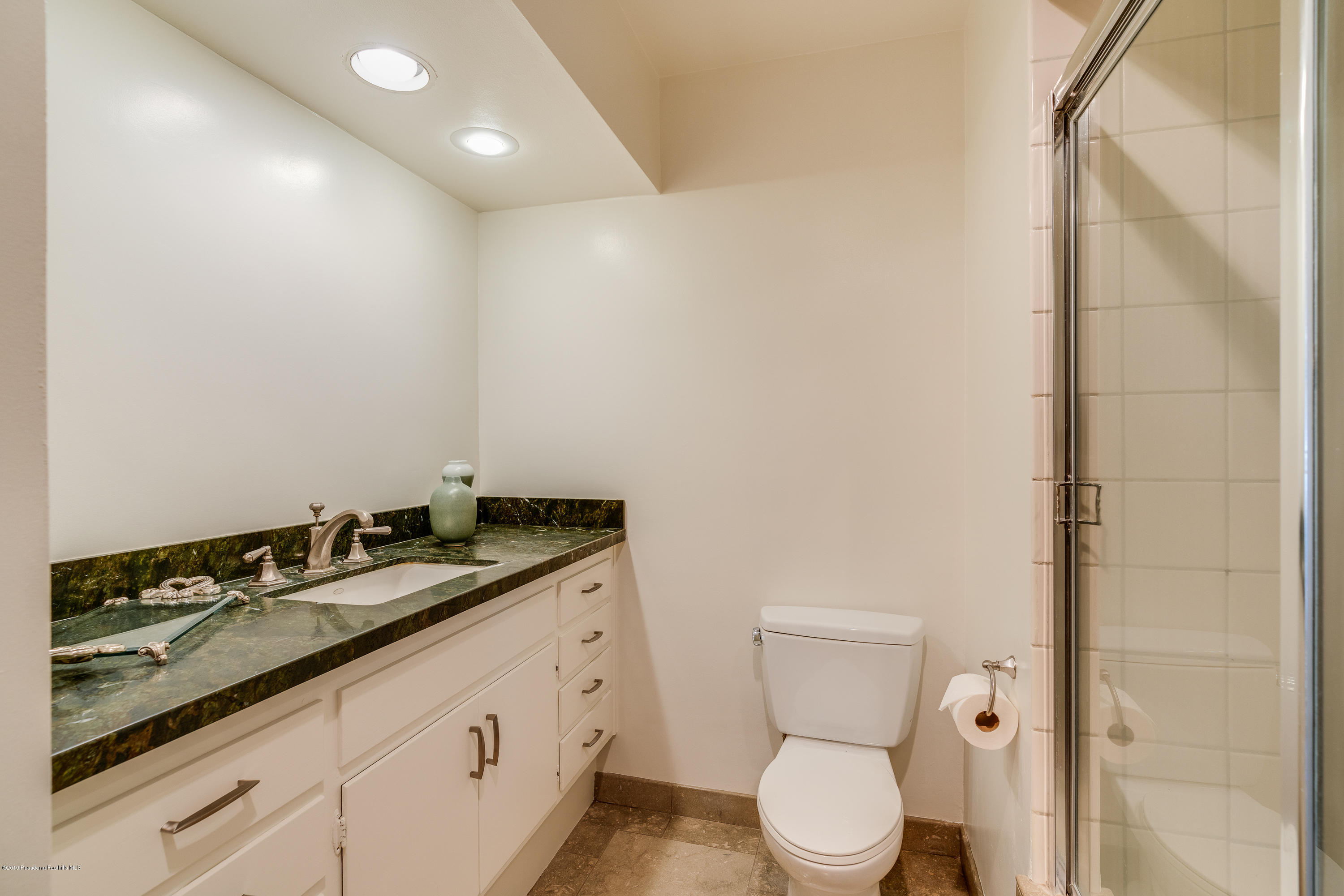2925 Lorain Road San Marino, CA 91108 - Photo 10 of 18 a bathroom with a granite countertop sink a toilet and a mirror