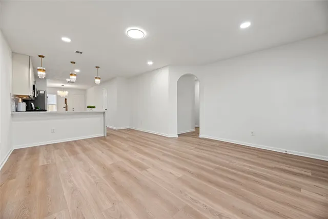 a view of a kitchen with a sink and a large window