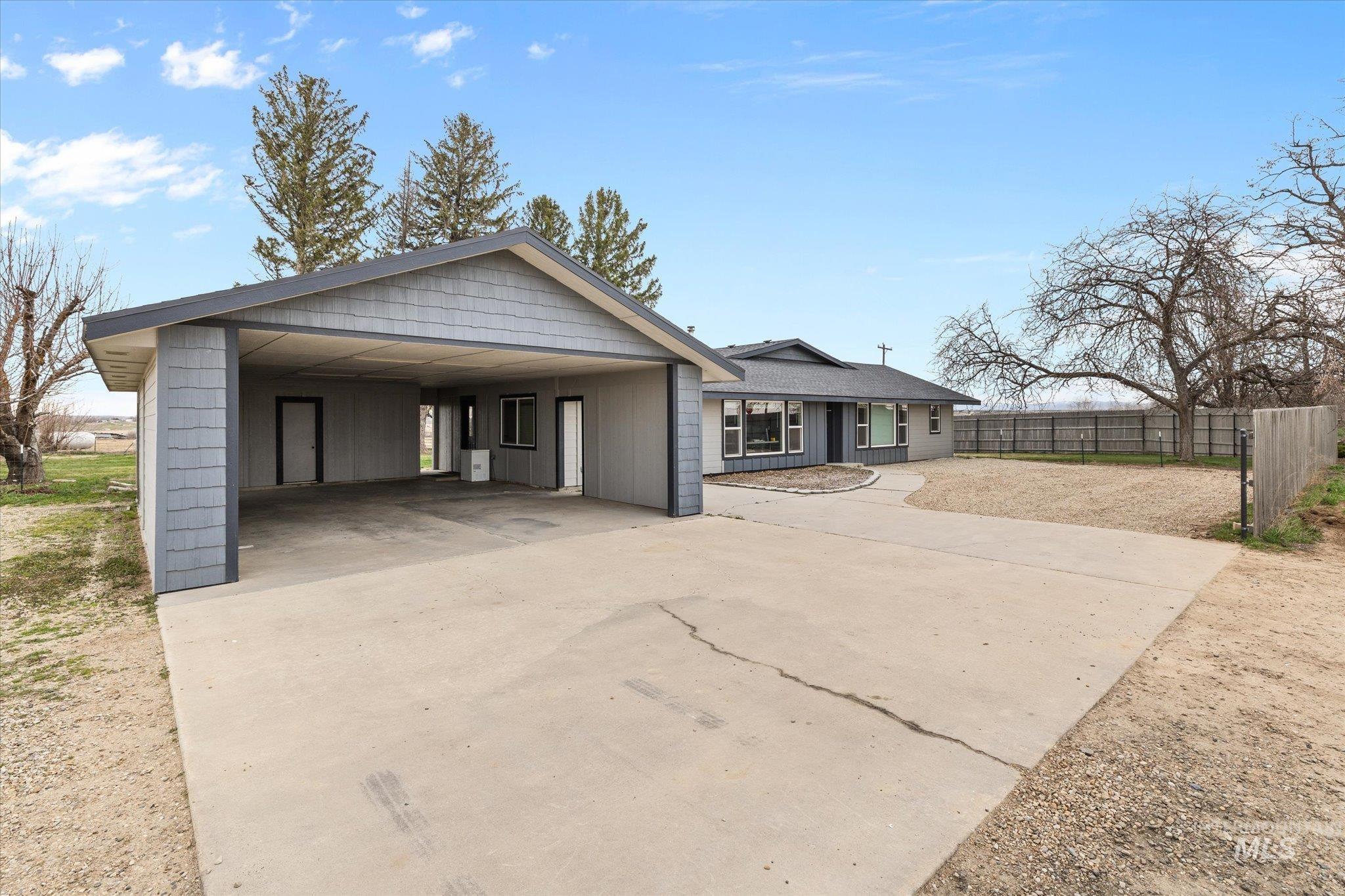 15032 Hollow Road Caldwell, ID 83607 - Photo 16 of 50 View of front facade with concrete driveway and board and batten siding