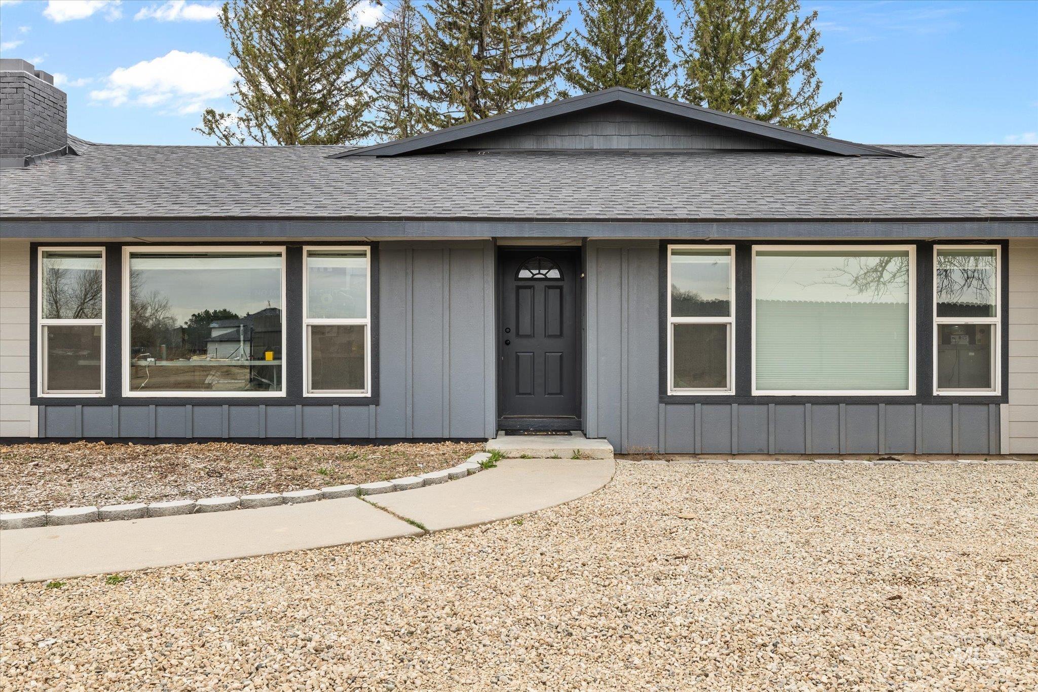 15032 Hollow Road Caldwell, ID 83607 - Photo 18 of 50 Single story home featuring roof with shingles, board and batten siding, and a chimney
