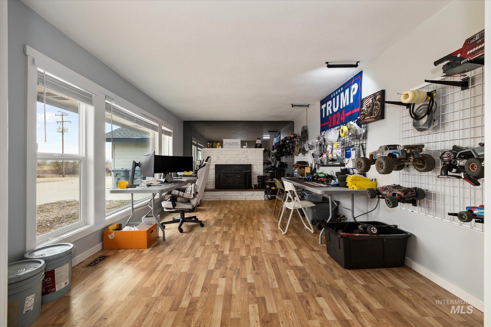 15032 Hollow Road Caldwell, ID 83607 - Photo 19 of 50 Office space featuring light wood-style flooring and a stone fireplace