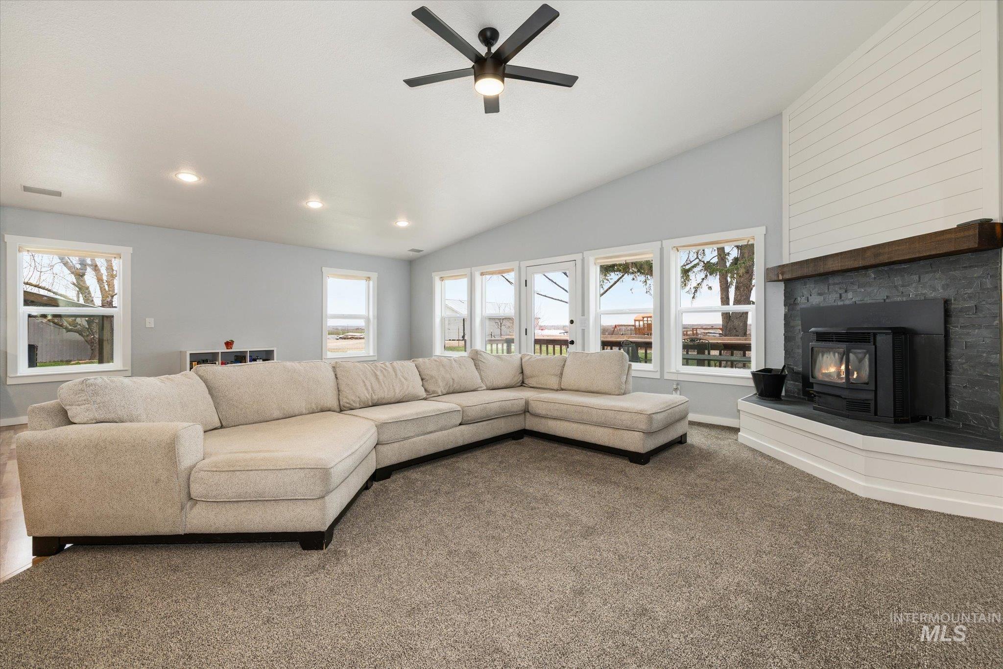 15032 Hollow Road Caldwell, ID 83607 - Photo 23 of 50 Living room with ceiling fan, lofted ceiling, and carpet flooring