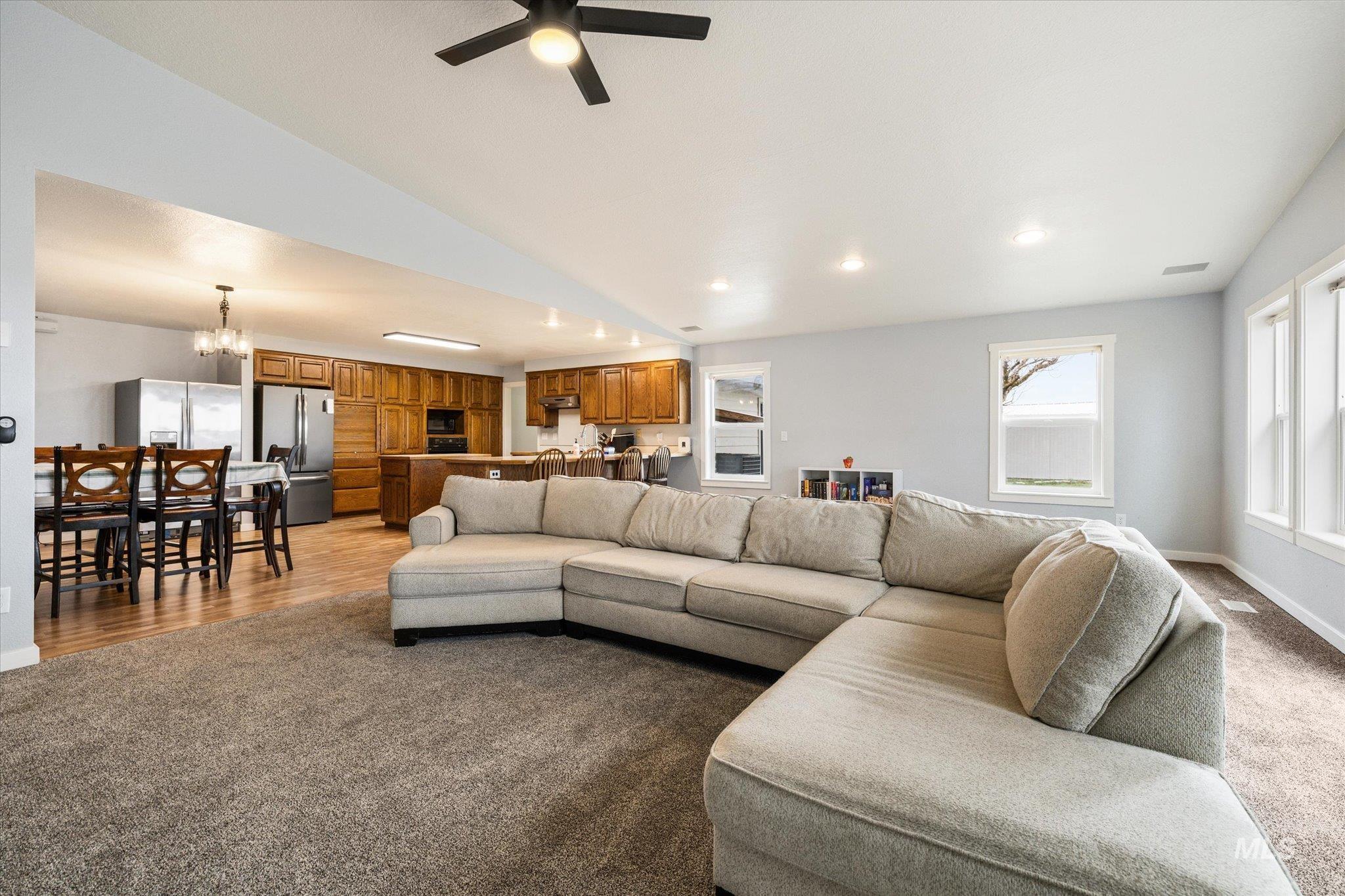 15032 Hollow Road Caldwell, ID 83607 - Photo 24 of 50 Living area with carpet, a ceiling fan, and a chandelier