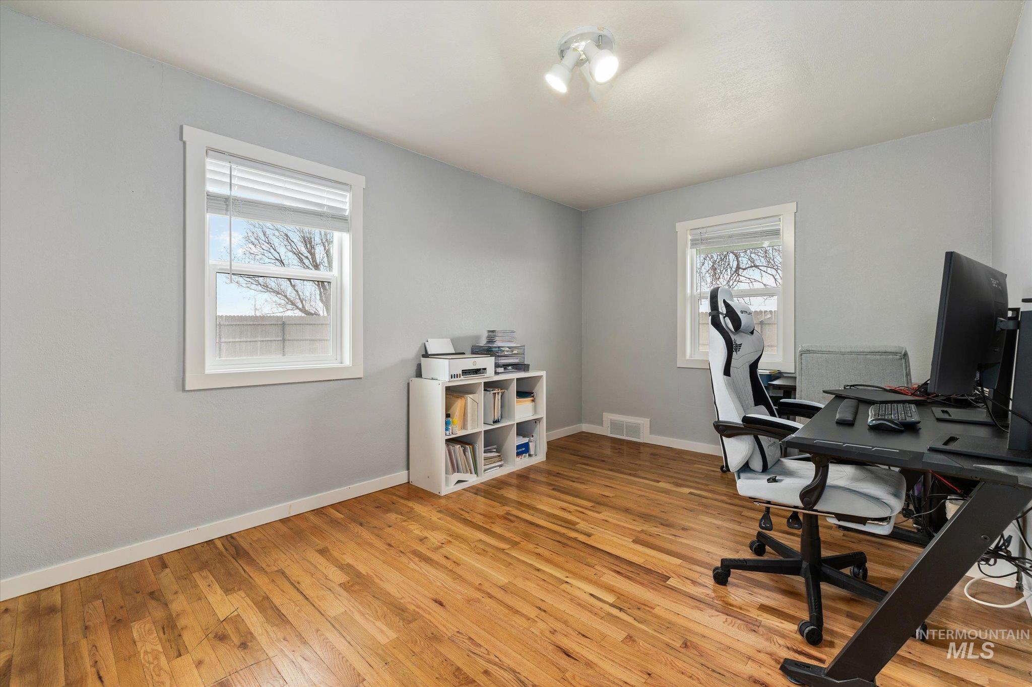 15032 Hollow Road Caldwell, ID 83607 - Photo 32 of 50 Home office featuring light wood-type flooring and baseboards