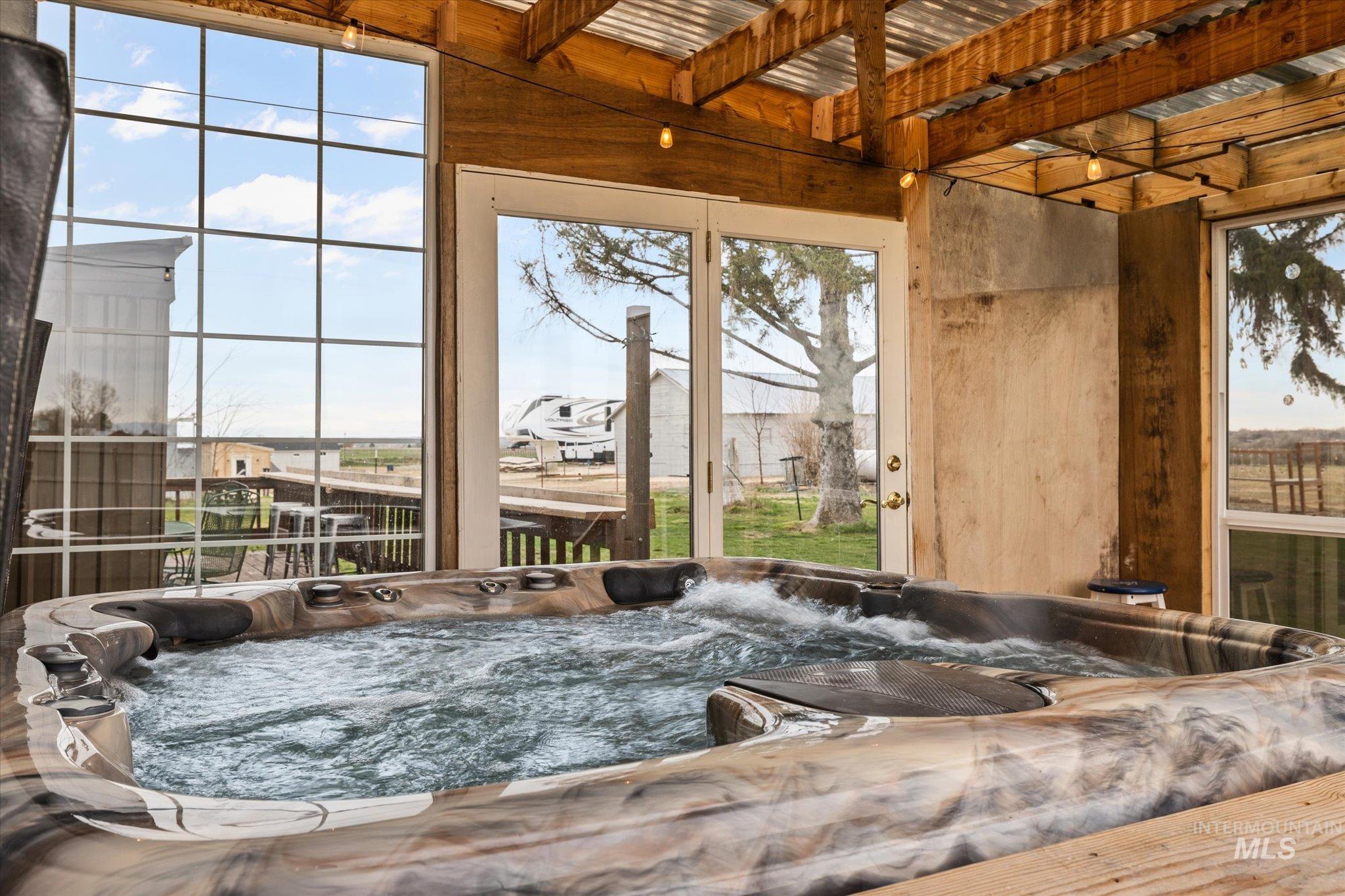 15032 Hollow Road Caldwell, ID 83607 - Photo 44 of 50 Sunroom with a hot tub and beam ceiling