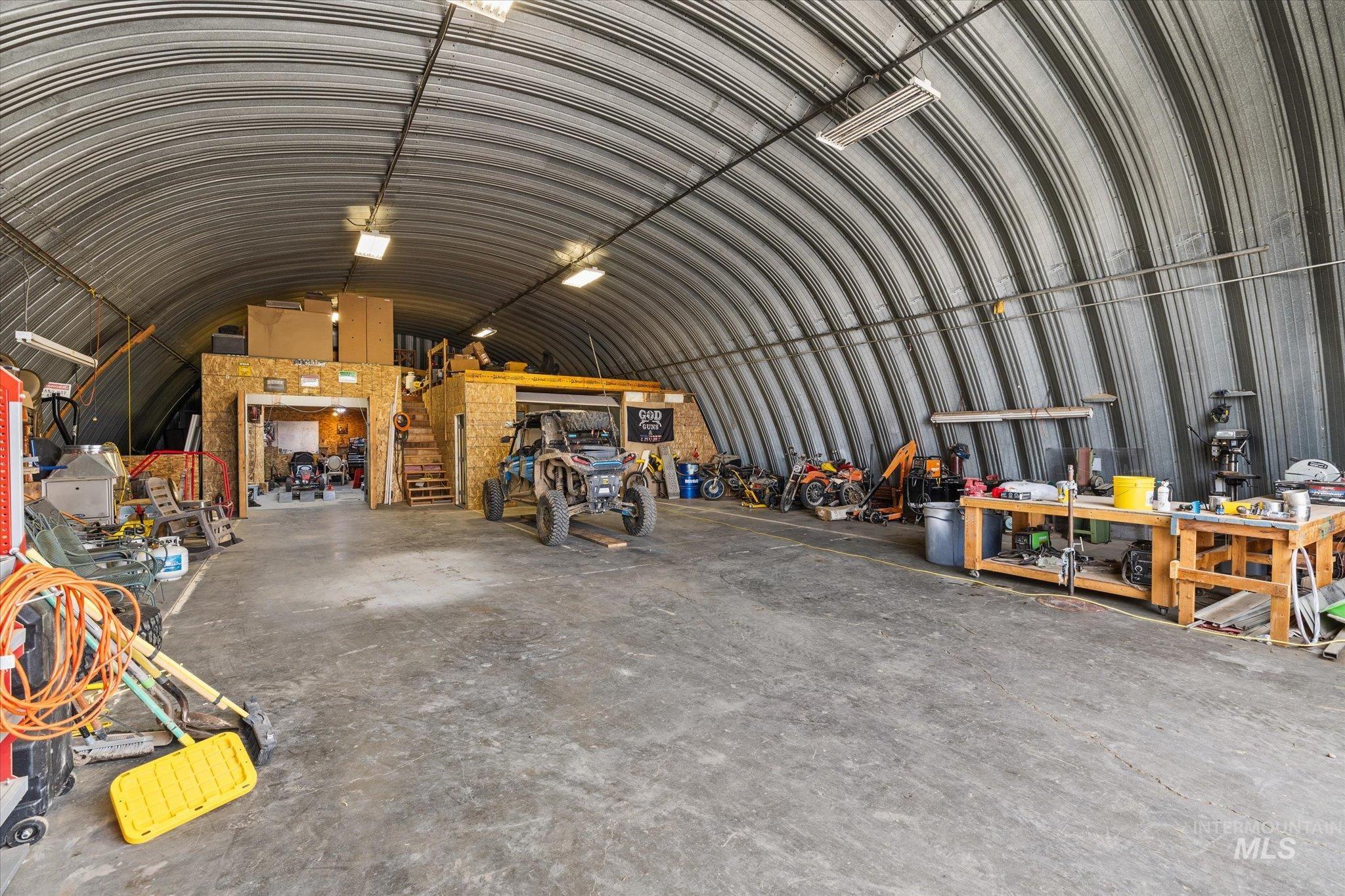15032 Hollow Road Caldwell, ID 83607 - Photo 48 of 50 Miscellaneous room with a barrel ceiling, a garage, metal wall, and a workshop area