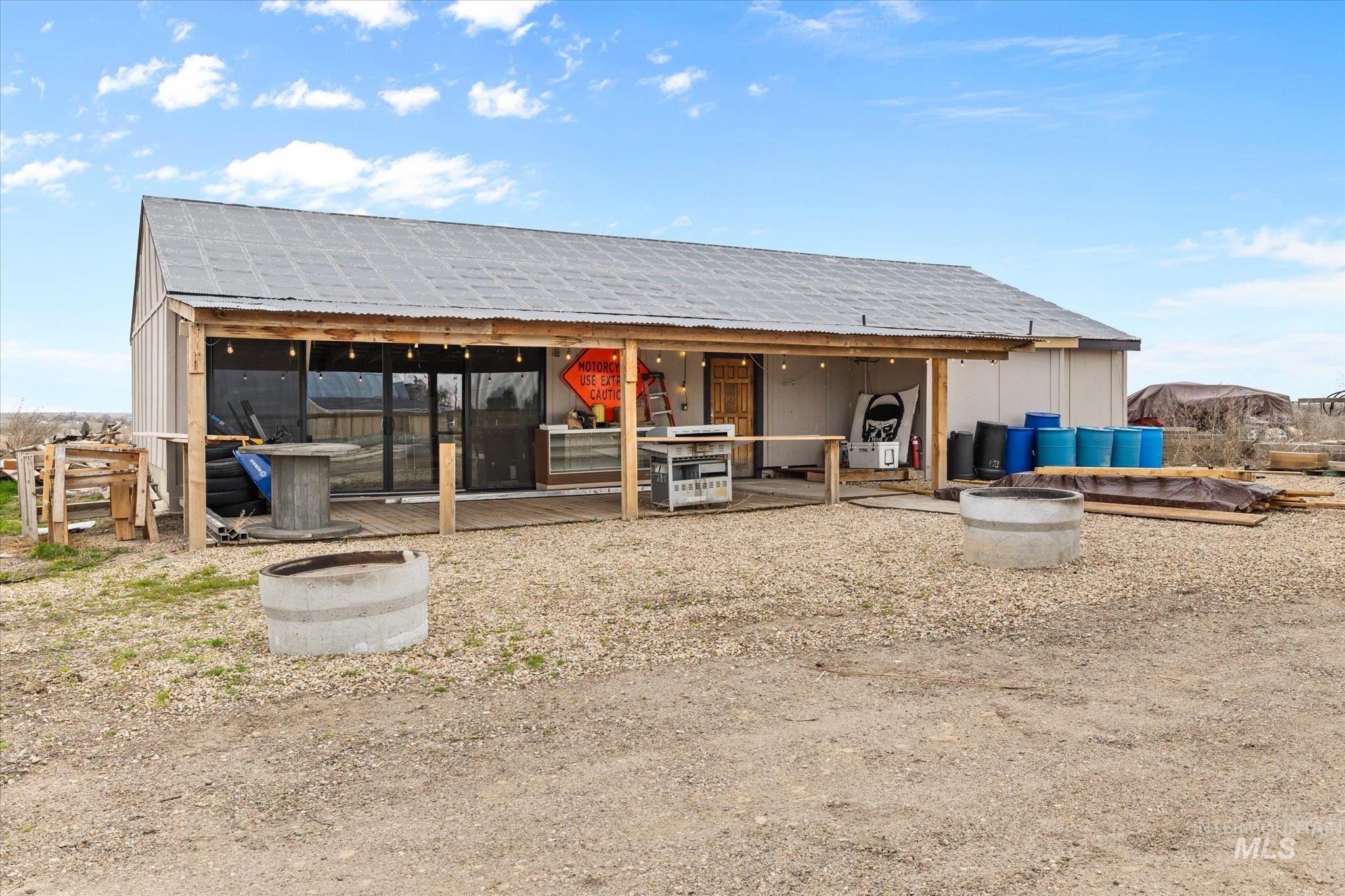 15032 Hollow Road Caldwell, ID 83607 - Photo 49 of 50 Back of house featuring an outbuilding and a patio area