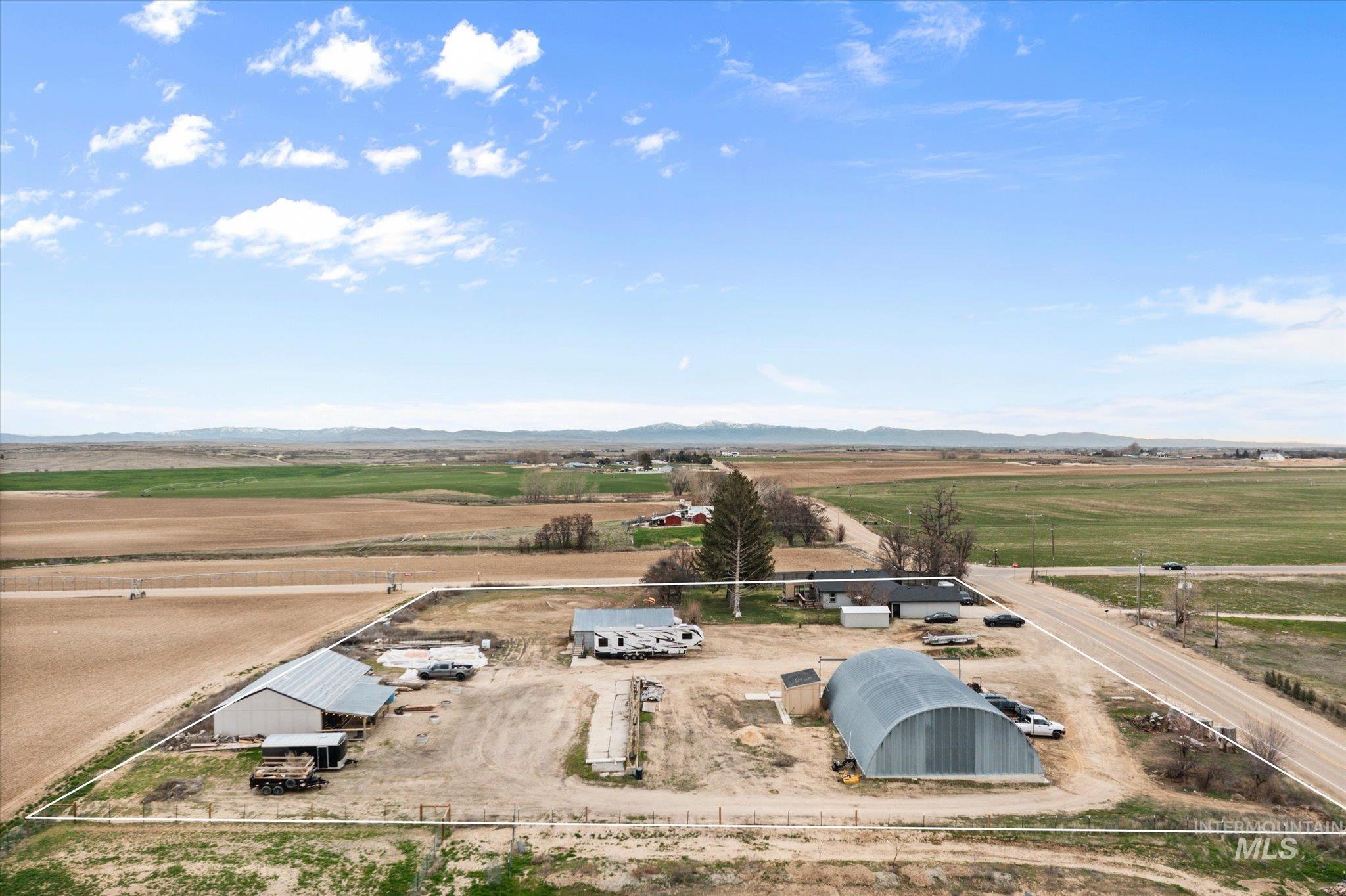 15032 Hollow Road Caldwell, ID 83607 - Photo 8 of 50 Aerial view of sparsely populated area with a mountain backdrop
