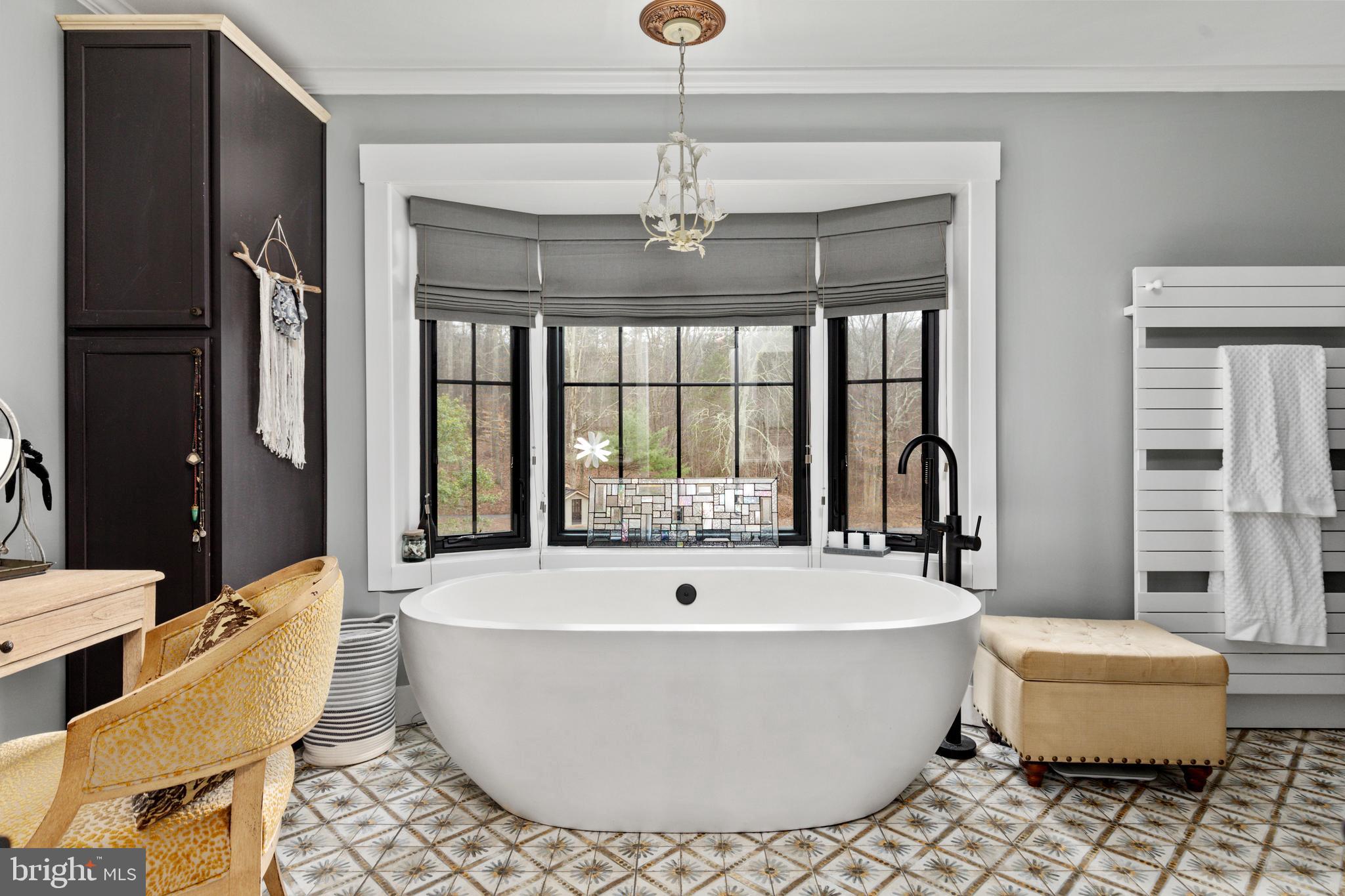 7464 Wilson Road Warrenton, VA 20186 - Photo 12 of 22 a living room with couches and a chandelier