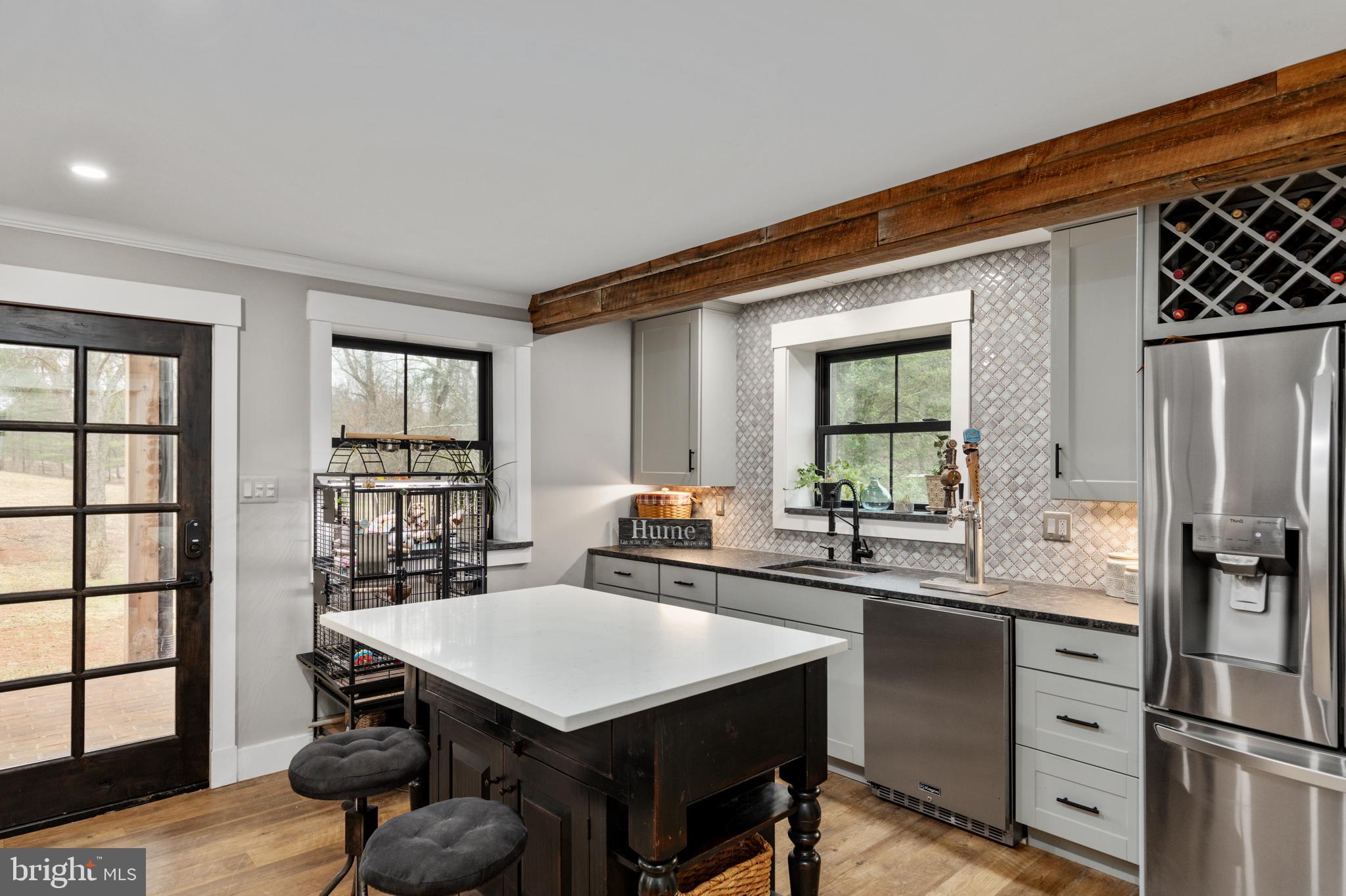 7464 Wilson Road Warrenton, VA 20186 - Photo 17 of 22 a kitchen with a table chairs refrigerator and cabinets