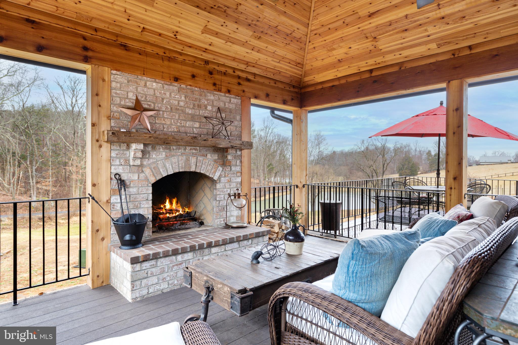 7464 Wilson Road Warrenton, VA 20186 - Photo 18 of 22 a living room with furniture a fireplace and a table
