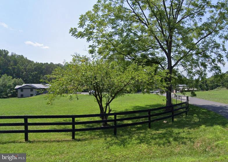 7464 Wilson Road Warrenton, VA 20186 - Photo 3 of 22 a view of a bench in a garden