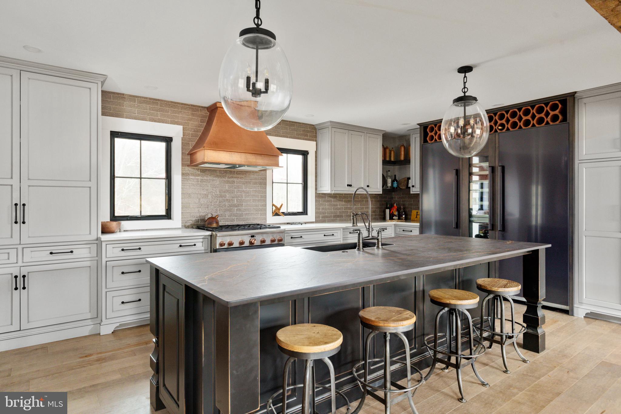 7464 Wilson Road Warrenton, VA 20186 - Photo 7 of 22 a kitchen with stainless steel appliances granite countertop a sink a stove and a wooden floors