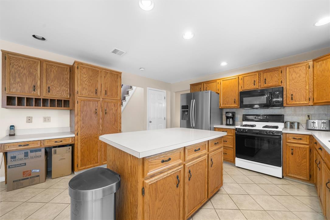 1255 Spring Road Easton, PA 18040 - Photo 7 of 23 Rich wood cabinetry paired with tiled flooring defines this traditional kitchen layout.