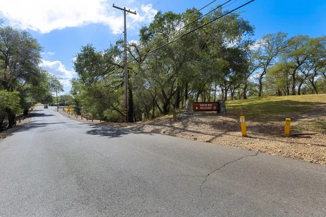 a view of a street with a house in the background