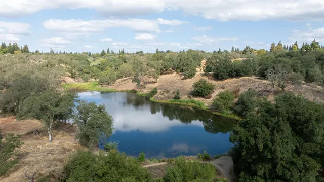 a view of a lake with houses in back