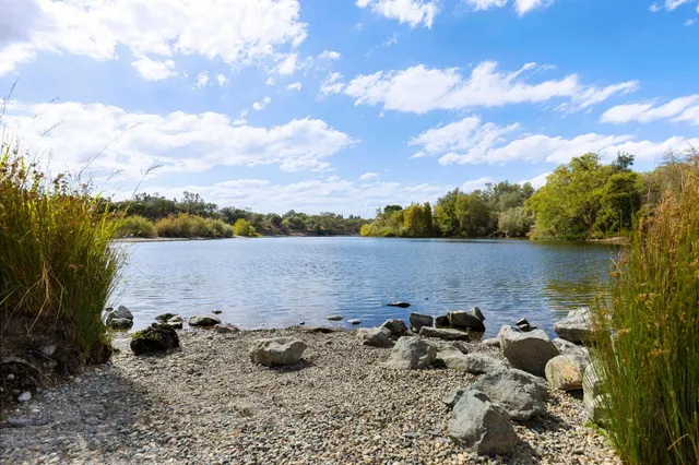 a view of a lake with houses in the back