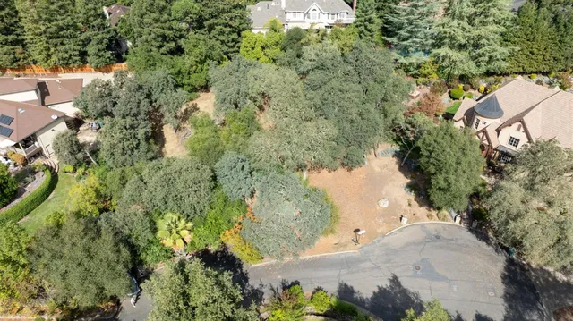 an aerial view of a house with a yard and lake view