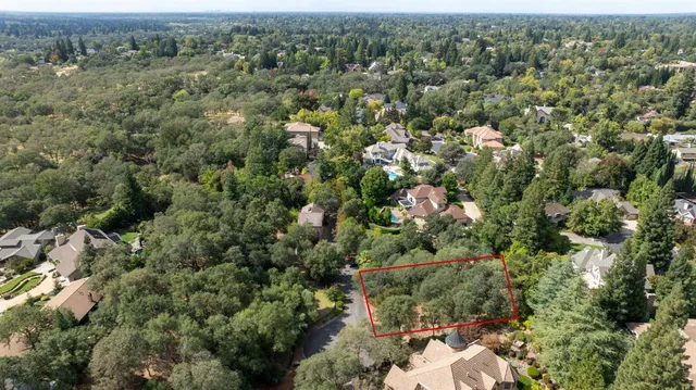 an aerial view of a houses with a yard