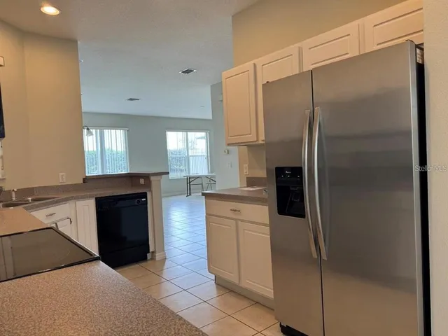 a kitchen with a refrigerator and a sink