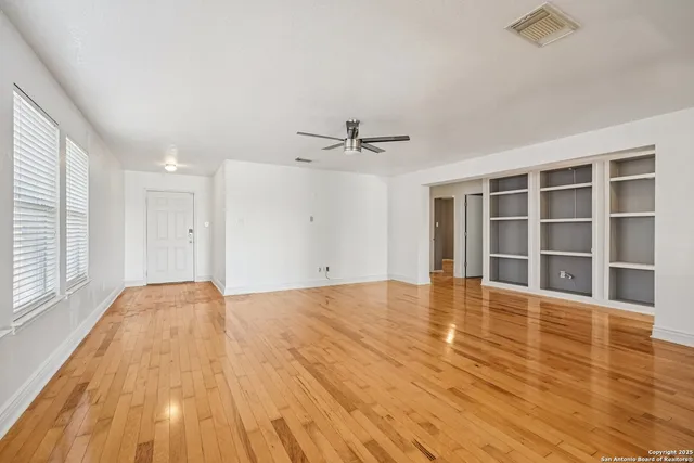 a view of a room with wooden floor and closet