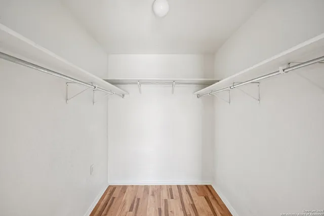 a view of a room with wooden floor and cabinet