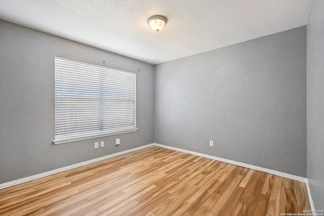 a view of a room with wooden floor