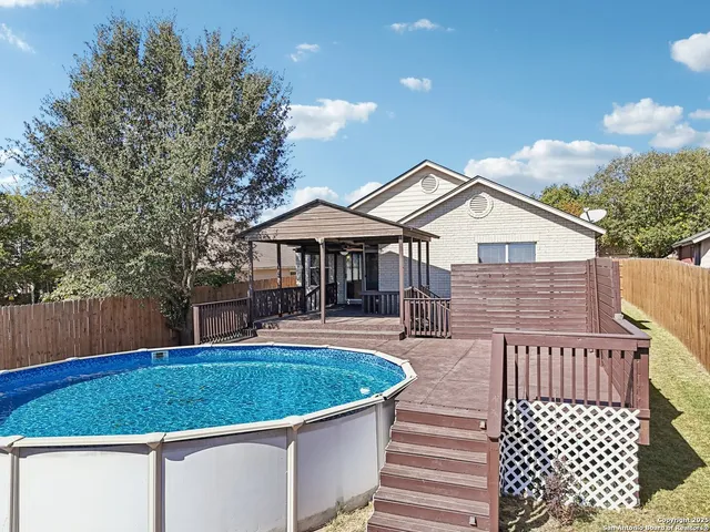 a view of a house with a swimming pool and sitting area