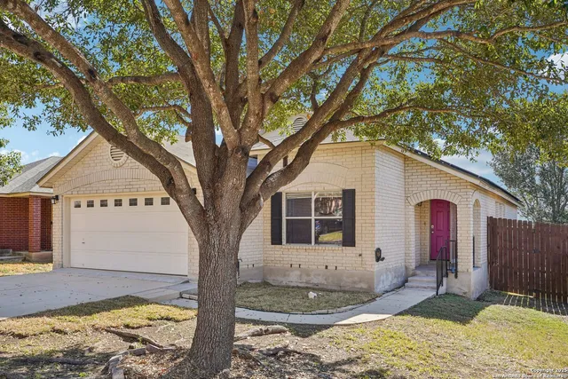 a view of a house with a yard and sitting area
