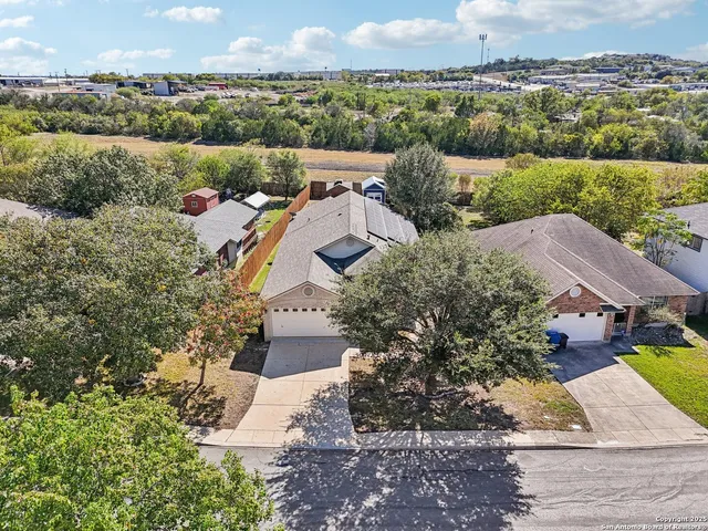 an aerial view of residential houses with outdoor space