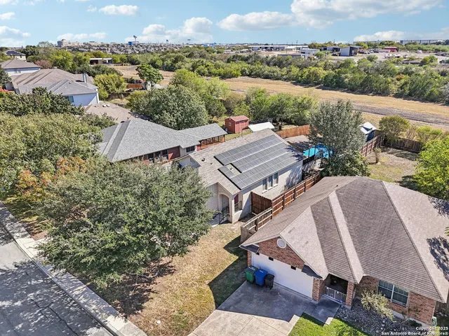an aerial view of residential houses with outdoor space