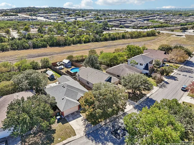 an aerial view of a house with a yard