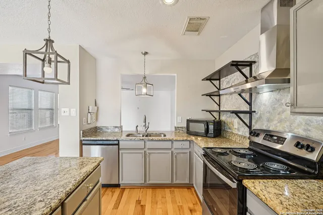 a kitchen with stove and cabinets