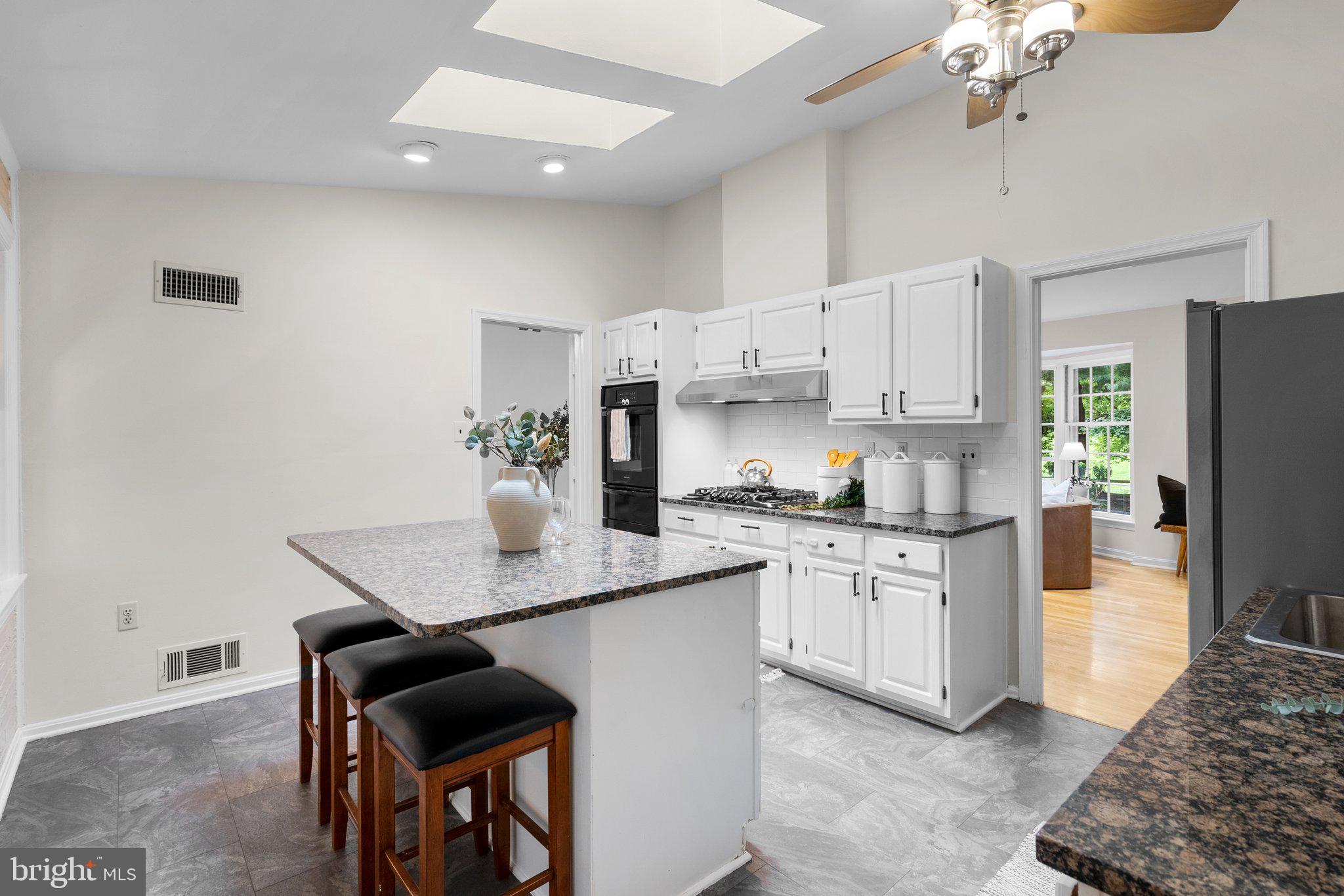 200 Eldrid Drive Silver Spring, MD 20904 - Photo 12 of 44 a kitchen with stainless steel appliances granite countertop a white cabinets and a stove