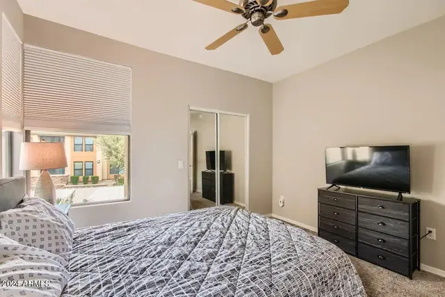 a bedroom with a bed and a flat screen tv