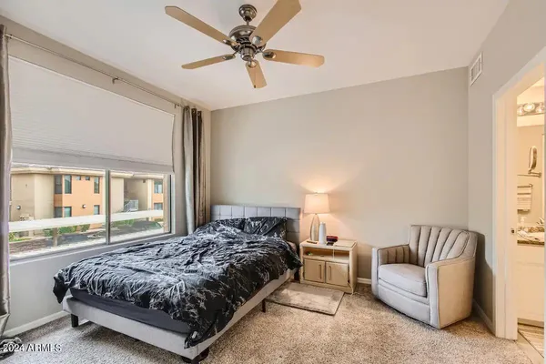 a bedroom with a bed couch and window