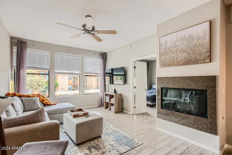 6900 East Princess Drive, Unit 2111 Phoenix, AZ 85054 - Photo 2 of 18 a living room with furniture and a fireplace