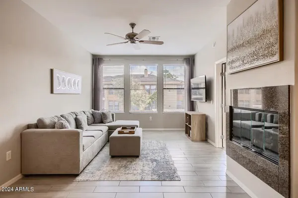 a living room with furniture and large windows
