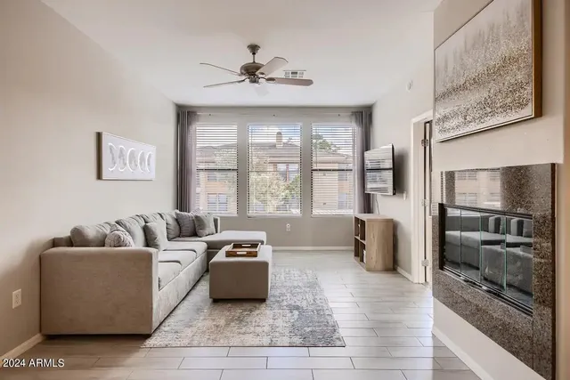 a living room with furniture and large windows