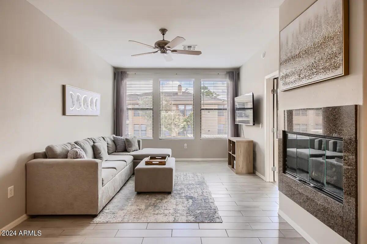 6900 East Princess Drive, Unit 2111 Phoenix, AZ 85054 - Photo 3 of 18 a living room with furniture and large windows
