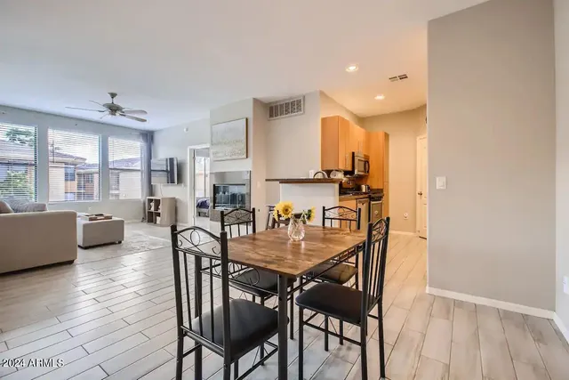a dining room with furniture and wooden floor
