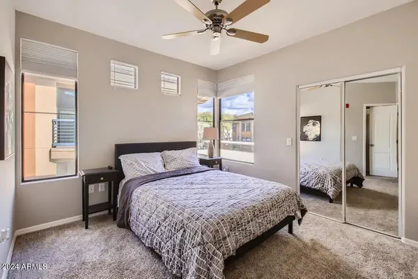 a bedroom with a bed and a chandelier