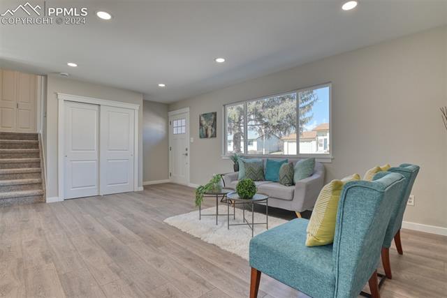 1913 Wooten Road Colorado Springs, CO 80915 - Photo 12 of 50 Living area with light hardwood / wood-style flooring
