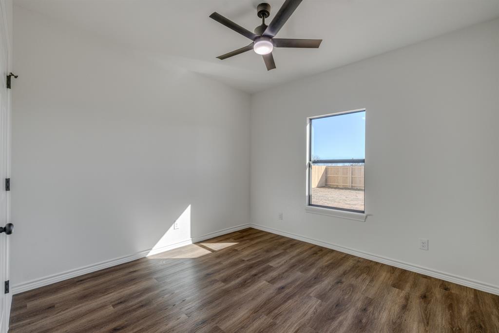 900 Ruger Drive Clyde, TX 79510 - Photo 11 of 11 wooden floor in an empty room with a window